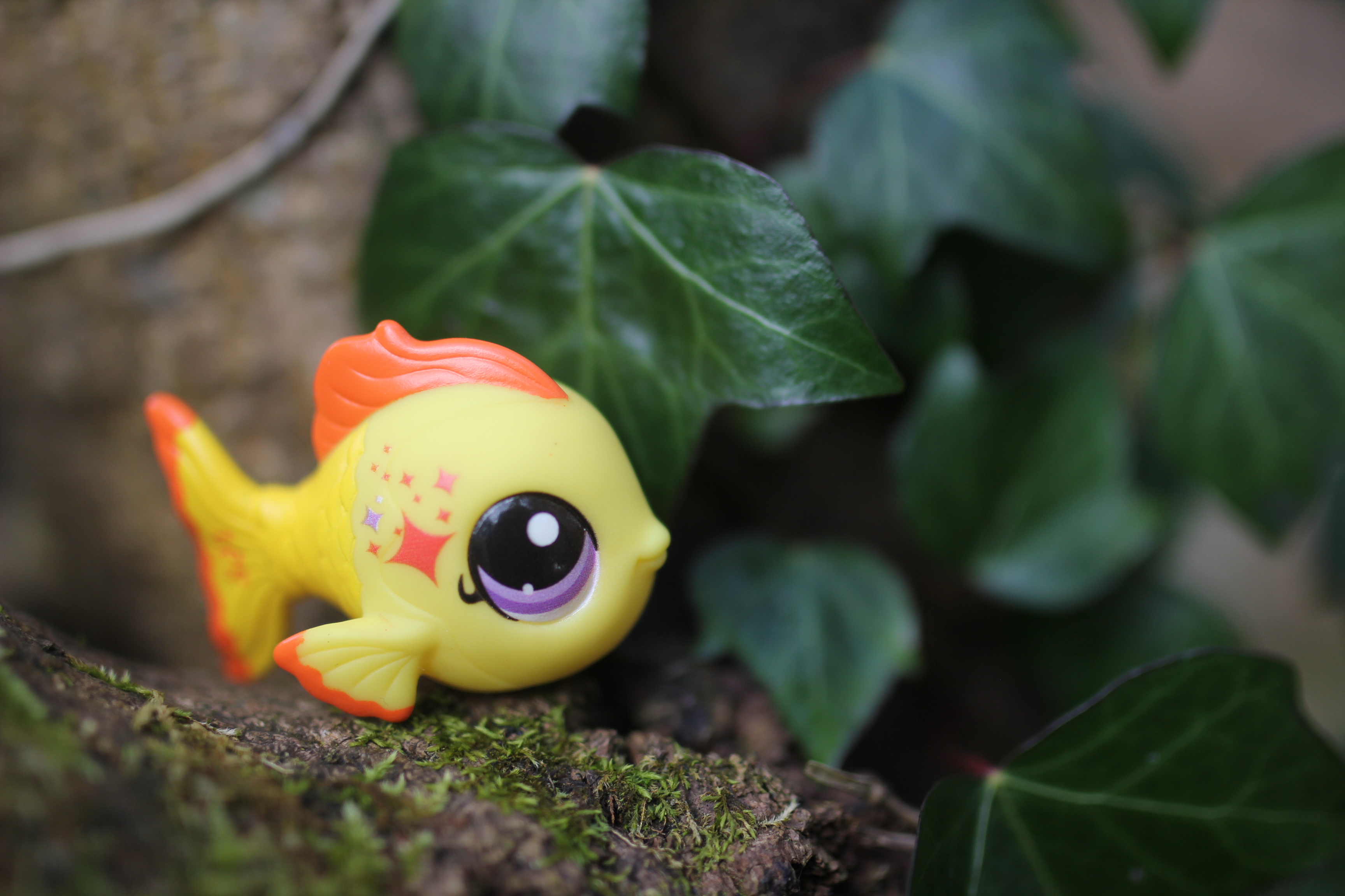 Small plastic yellow fish in a tree.